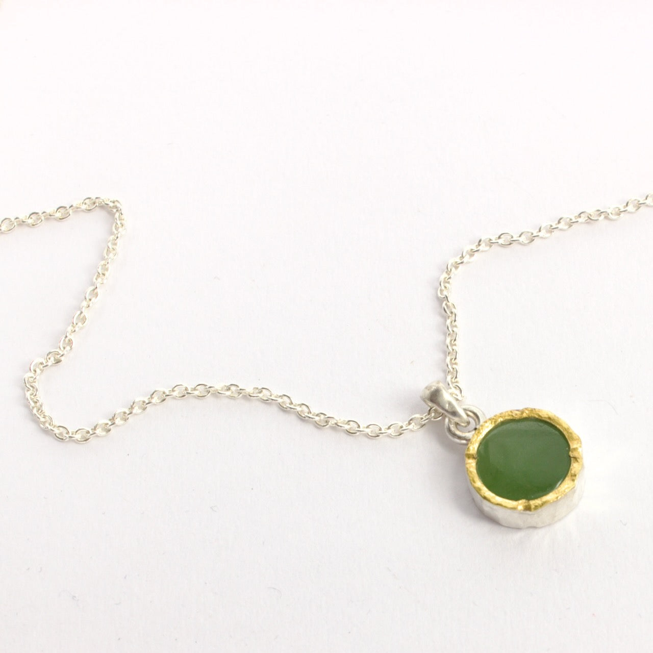 DM380C: Light pounamu gold edged pendant