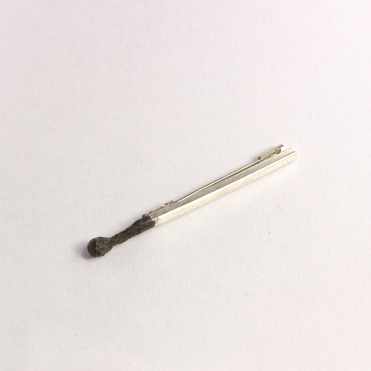 DM822B: Burnt matchstick brooch
