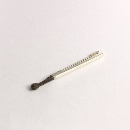 DM822B: Burnt matchstick brooch