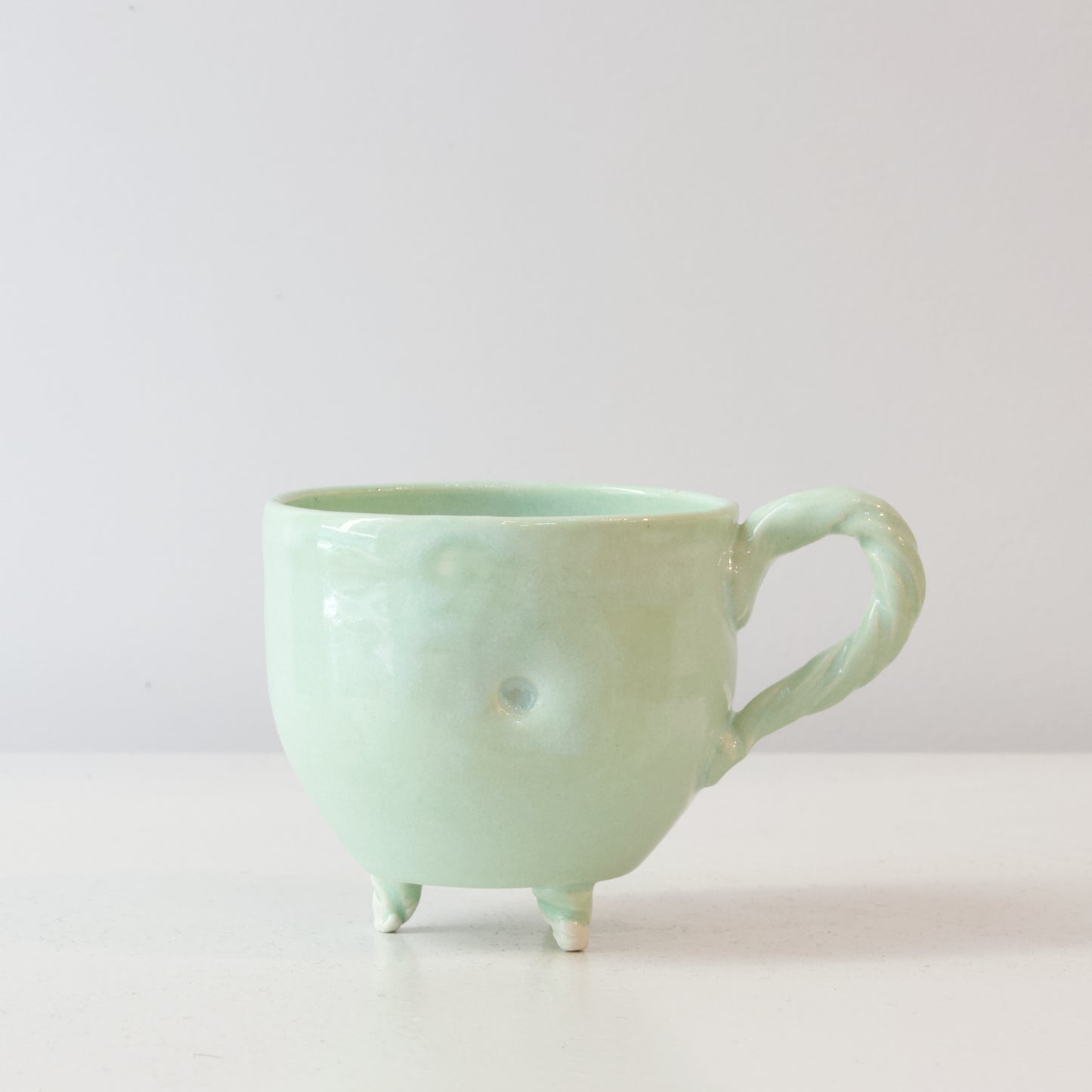 NML320: Celadon green cup with feet