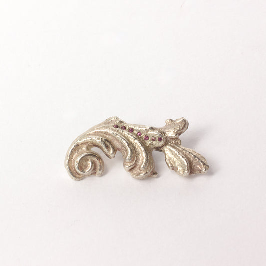 VM120: Sand cast scroll brooch