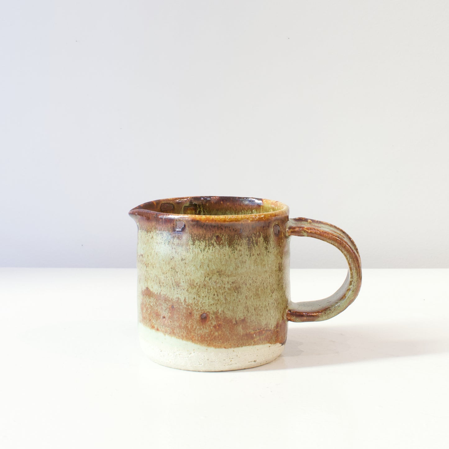 HP117: Brown and green glazed jug